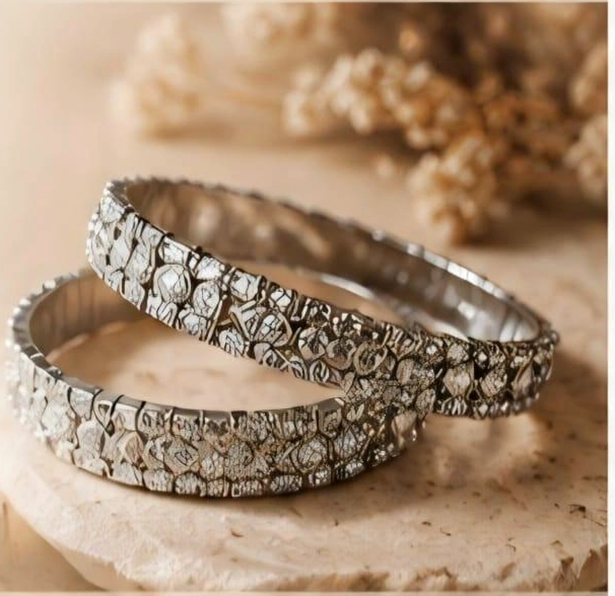 Silver gemstone bangles, warmly photographed on sandstone